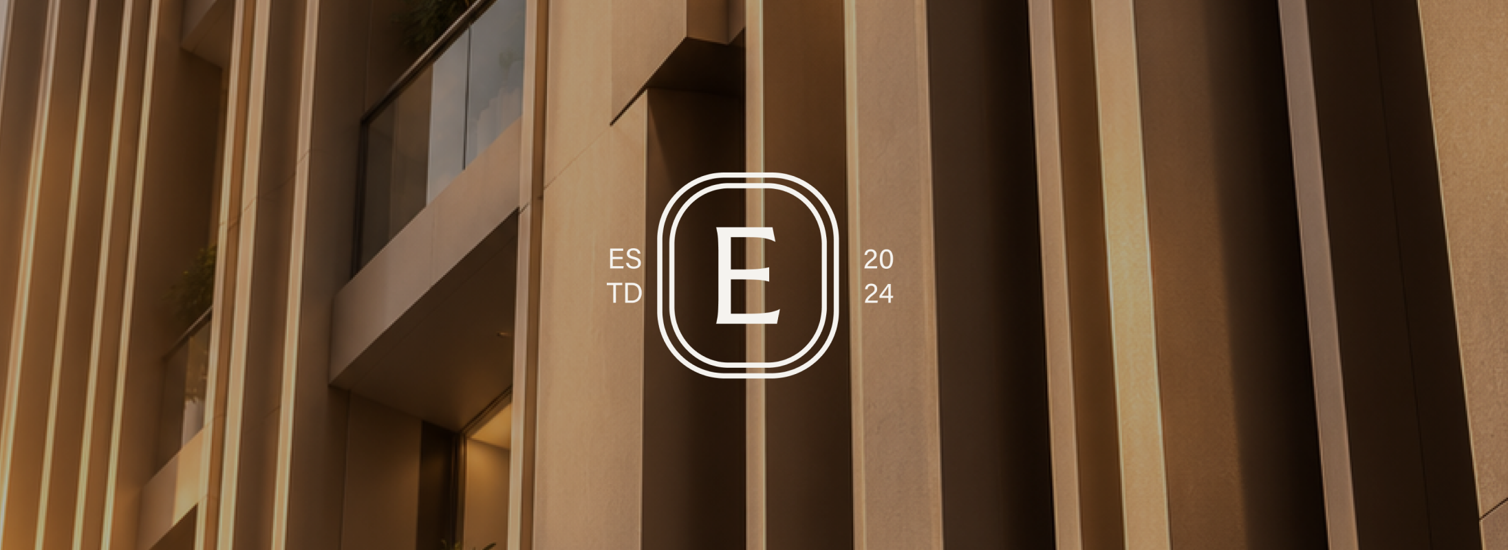 Elena monogram over a residential building facade.